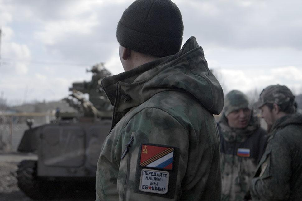 Soldier in a front of a tank
